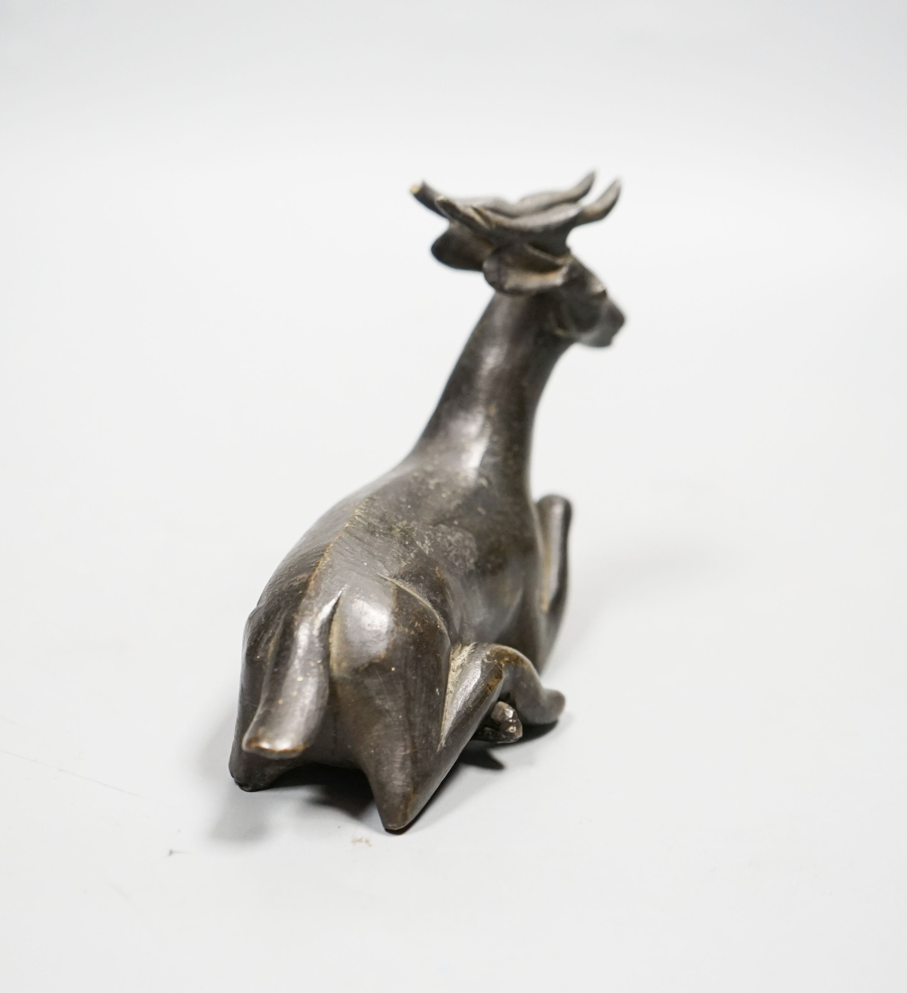 A Chinese early bronze figure of a deer, probably Yuan to Ming period, 13.5cm